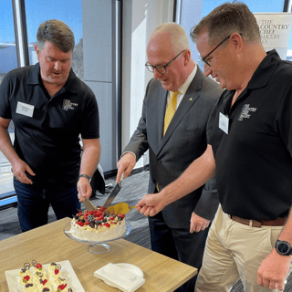 Bradley Forde, Mayor Jamieson and Dion Nolan, at the Country Chef opening cutting a pavlova