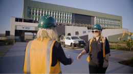 Two people in high vis vests shake hands 